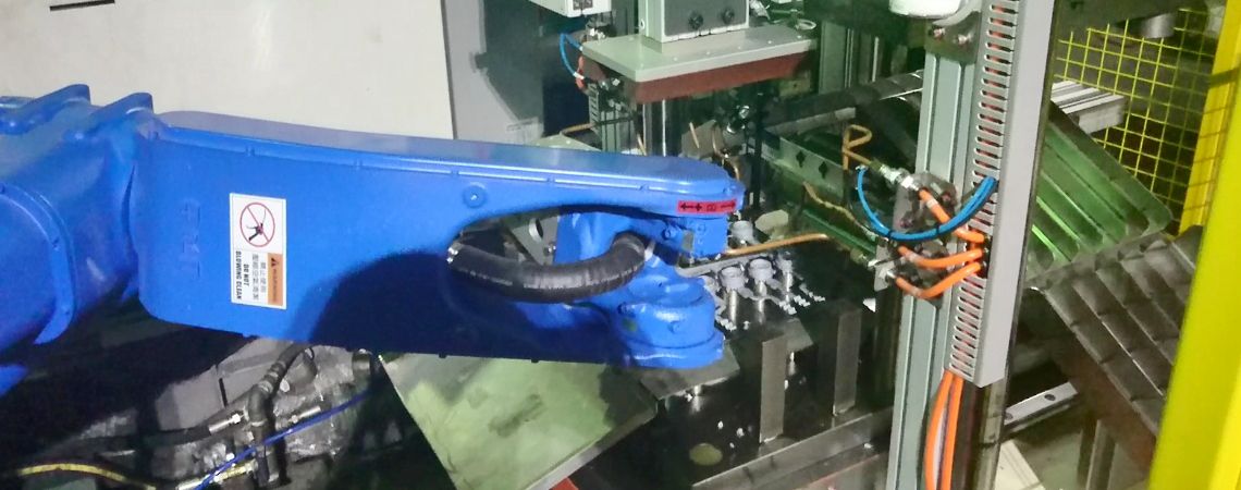 The Yaskawa motoman GP25 robotic arm, in conjunction with the hydraulic punch press, punches and cuts products with a 1-die 12-hole configuration into different baskets.